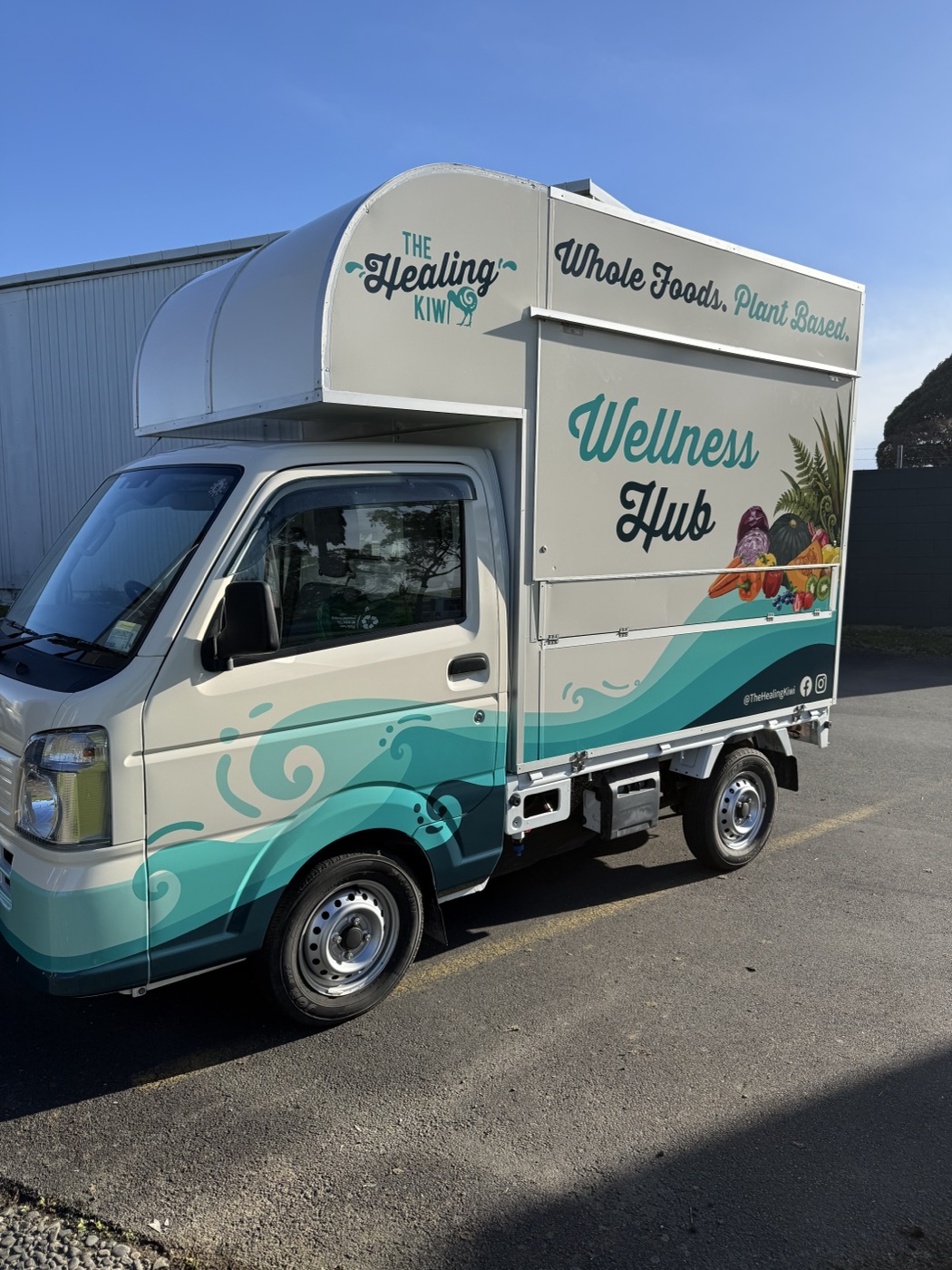 Side of the truck with the Wellness Hub artwork and 'Whole Foods. Plant Based.'